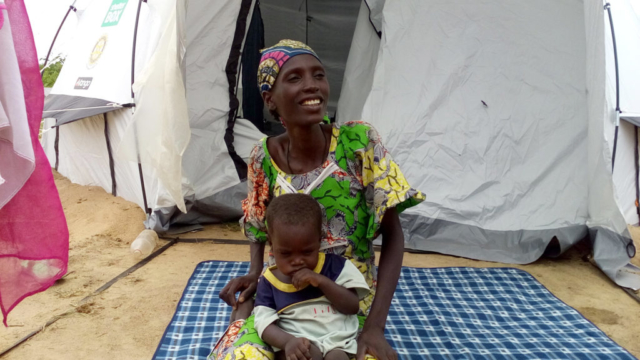 A mother and her child outside their shelter in Cameroon