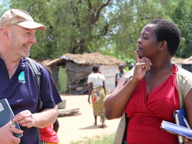 Two people talking and laughing together.