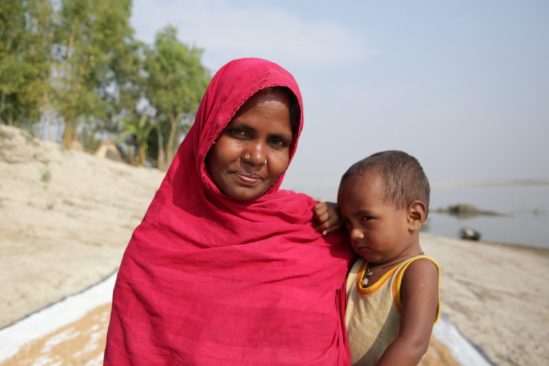 SB_Bangladesh_Behula_20191214_06 A woman stands on a beach holding a young child