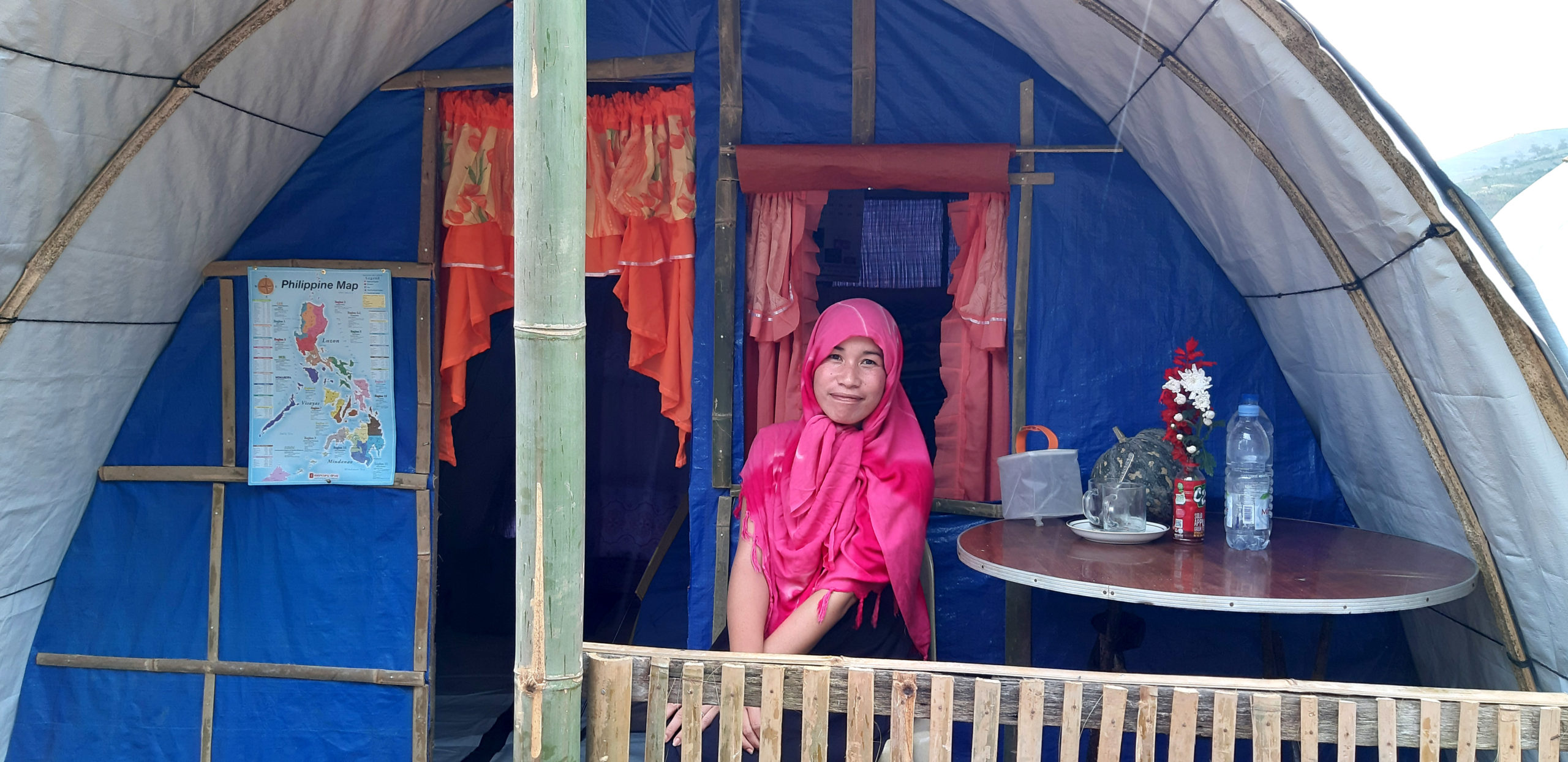 Woman sitting in front of her shelter