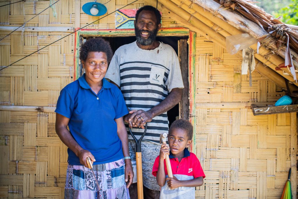 Sebastiana and son John outside their home.