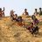 Children sliding down a mud hill on water carriers