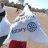 Person holding a bag of aid that says ShelterBox and Rotary