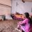 Shewit and another woman sit on the ground inside the displacement shelter.