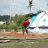 Erit carefully rakes her grains on a tarpaulin