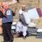 A man holds aid items and talks to a member of United Peace Organization.