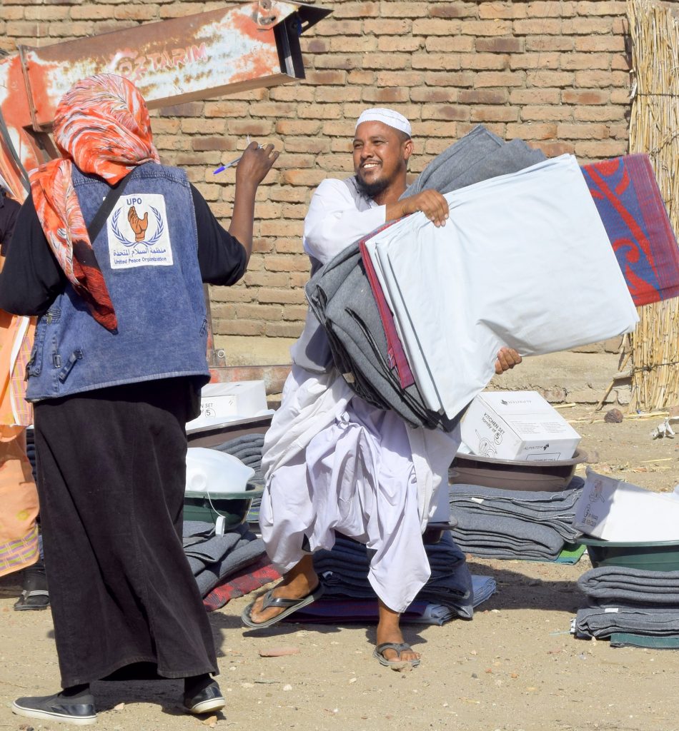 Distributing the tarpaulins and blankets