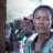 Ethiopian woman sits in crowd of people during aid assessments