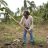 Filippino woman uses hoe to prepare the ground for planting.