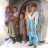 A Pakistani mother and her children stand in front of the entrance to their tent.