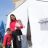 A woman stands in front of a tent with her two children